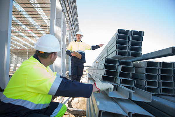 Daily Safety Meetings | Geer Structural Construction Construction crew conducting a daily jobsite safety meeting before structural steel work begins.
