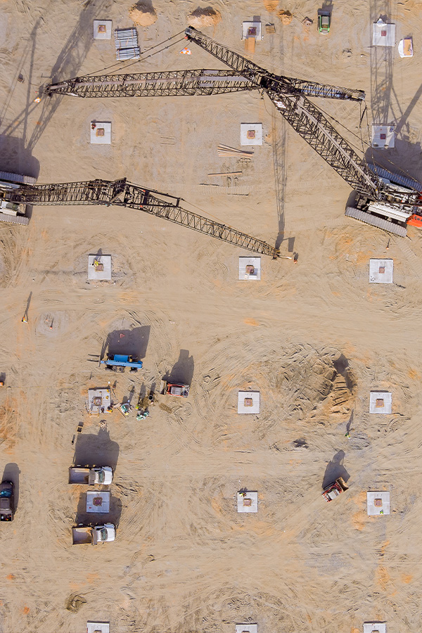 Ironworker installing structural steel beams during commercial construction.