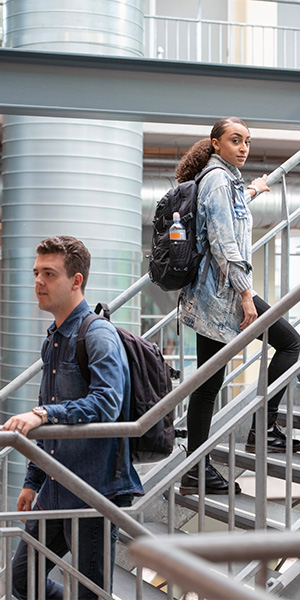School and Education Construction | Geer Structural Construction Students walking through a modern school building representing educational construction projects.