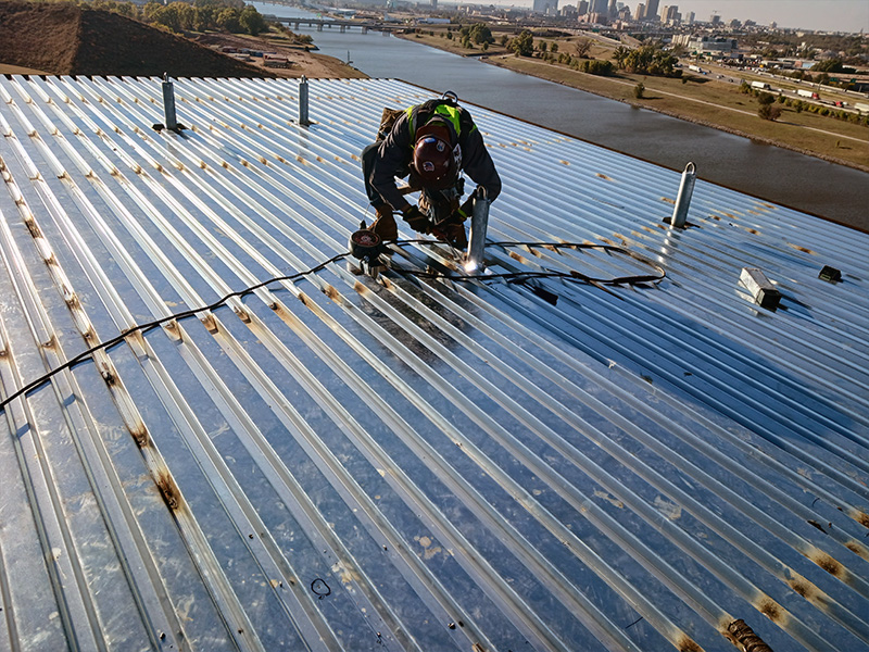 Steel Decking Installation | Geer Structural Construction Ironworker installing steel decking on commercial construction project in Oklahoma City