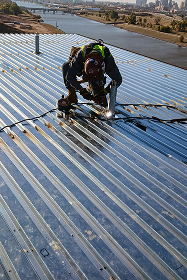 Ironworker installing structural steel beams during commercial construction.