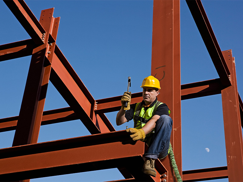 Structural Steel Erection Services | Geer Structural Construction Ironworker installing structural steel beams during commercial building construction.
